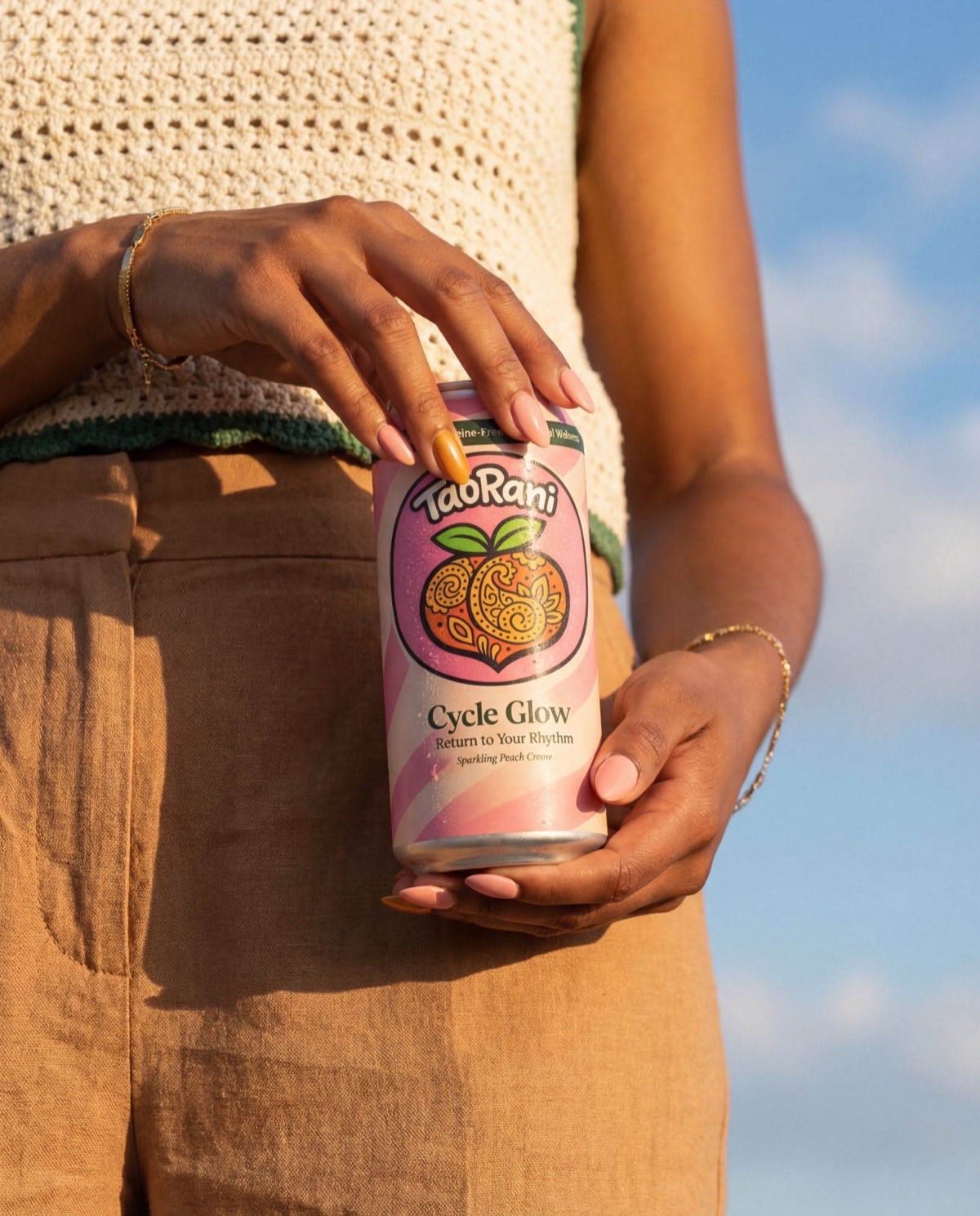 Woman holding TaoRani Cycle Glow against a bright sky